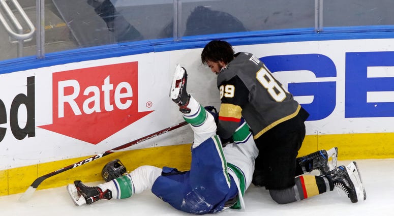 Vegas Golden Knights right wing Alex Tuch (89) fights with Vancouver Canucks right wing Jake Virtanen (18) during the third period in game two of the second round of the 2020 Stanley Cup Playoffs at Rogers Place.