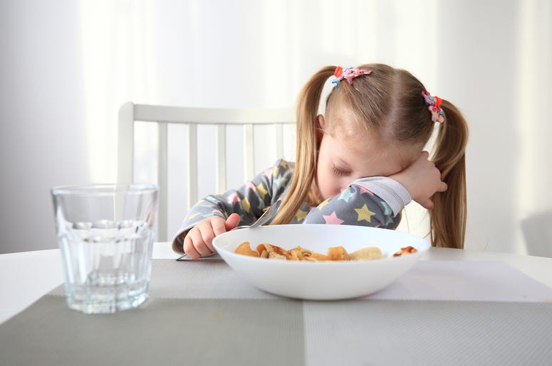 sleepy kid at breakfast