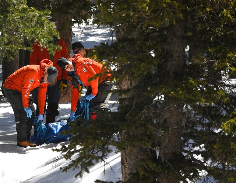 Members of an Alpine Rescue Team carry out the body of 18-year-old Sol Pais, near Echo Lake Campground in Arapaho National Forest, Wednesday, April 17, 2019, in Idaho Springs, Colo. Members of an Alpine Rescue Team