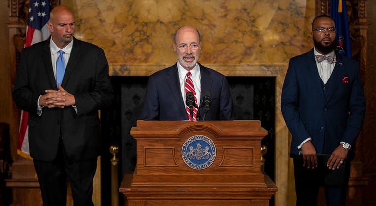 Lt. Gov. John Fetterman (L), Gov. Tom Wolf (C) and Board of Pardons Secretary Brandon Flood (R). Gov. Wolf, Lt. Gov, Pardons Board Provide Update on Pardons Process, Benefit to Those with Marijuana Convictions.
