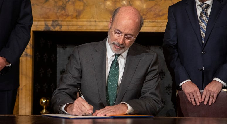 Gov. Tom Wolf signs an executive order in Harrisburg that intends to combat climate change and carbon emissions in Pennsylvania, Oct. 3, 2019. Gov. Tom Wolf