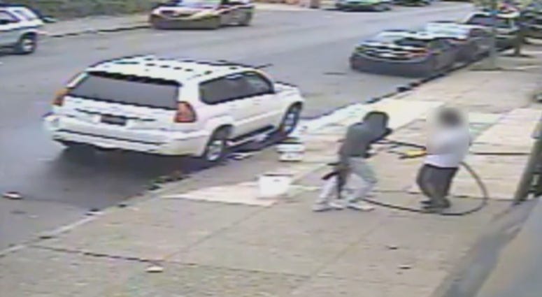 Video surveillance captures Jovaun Patterson approaching Li "Mike" Poeng with an AK-47 at 54th and Spruce streets, May 8, 2018. Video surveillance captures Jovaun Patterson approaching Li "Mike" Poeng with an AK-47 at 54th and Spruce streets, May 8, 2018.