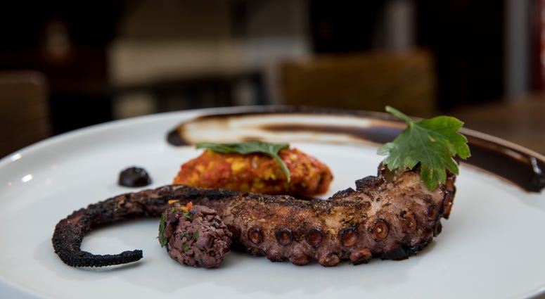 Octopus with almond romesco, olives and citrus at Stina. Stina restaurant