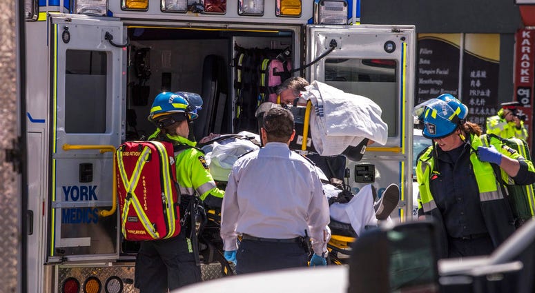A injured person is put into the back of an ambulance in Toronto after a van mounted a sidewalk crashing into a crowd of pedestrians. A injured person is put into the back of an ambulance in Toronto after a van mounted a sidewalk crashing into a crowd of pedestrians.
