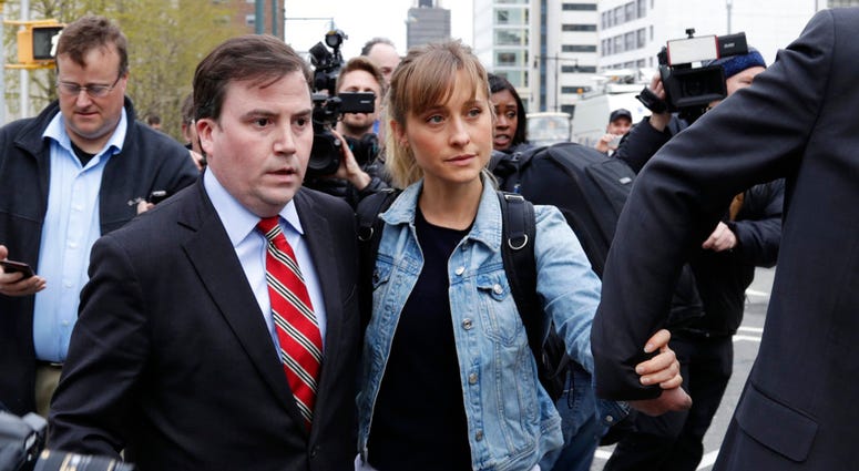 Allison Mack is escorted away from federal court Tuesday, April 24, 2018, in the Brooklyn borough of New York. Allison Mack