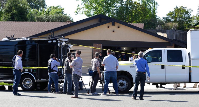 A car is backed out of the garage of a home searched in connection with the arrest of a man on suspicion of murder. A car is backed out of the garage of a home searched in connection with the arrest of a man on suspicion of murder.