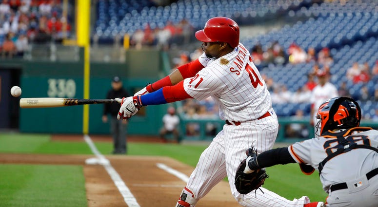 Philadelphia Phillies' Carlos Santana hits an RBI-double off San Francisco Giants starting pitcher Chris Stratton during the first inning. Philadelphia Phillies' Carlos Santana hits an RBI-double off San Francisco Giants starting pitcher Chris Stratton during the first inning.
