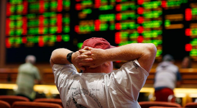 A man watches a baseball game in the sports book at the South Point hotel-casino in Las Vegas. A man watches a baseball game in the sports book at the South Point hotel-casino in Las Vegas.