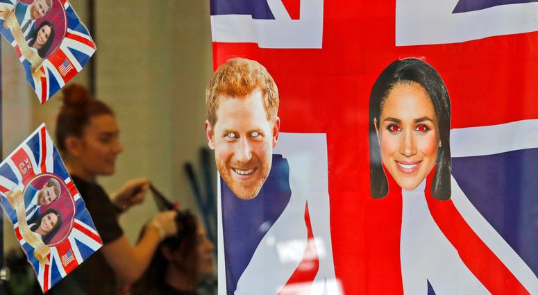 A window is decorated with flags and pictures of Britain's Prince Harry and Meghan Markle in Windsor. A window is decorated with flags and pictures of Britain's Prince Harry and Meghan Markle in Windsor.