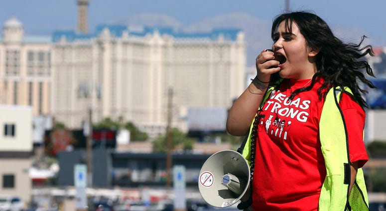 Volunteer Jenifer Murias yells into a megaphone as Culinary Union members file into a university arena to vote on whether to authorize a strike. Volunteer Jenifer Murias yells into a megaphone as Culinary Union members file into a university arena to vote on whether to authorize a strike.