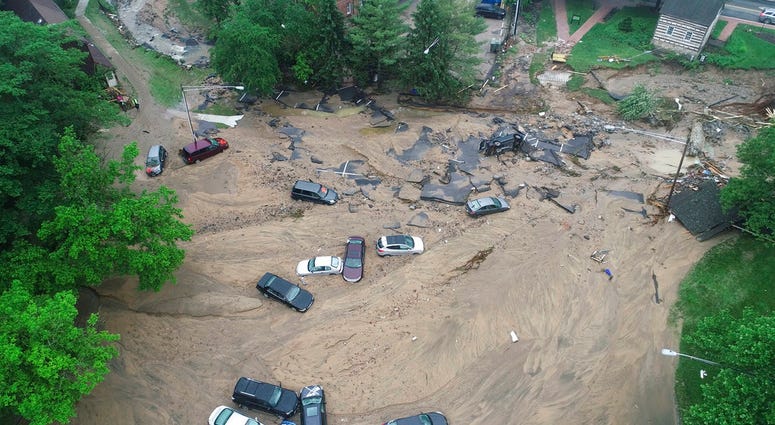 Vehicles swept by floodwater near the intersection of Ellicott Mills Drive and Main Street in Ellicott City, Md. Vehicles swept by floodwater near the intersection of Ellicott Mills Drive and Main Street in Ellicott City, Md.