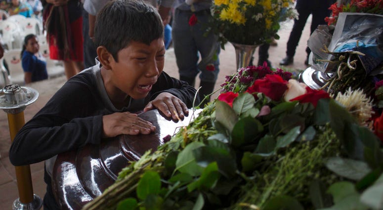 A youth cries over the coffin of Nery Otoniel Gomez Rivas, 17, whose body was pulled from the volcanic ash during the eruption of the Volcan de Fuego, during his wake. A youth cries over the coffin of Nery Otoniel Gomez Rivas, 17, whose body was pulled from the volcanic ash during the eruption of the Volcan de Fuego, during his wake.
