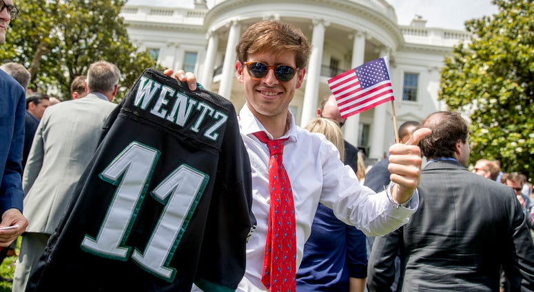 Tim Dagit of Chester Springs, Pa. holds up an Philadelphia Eagles jersey for quarterback Carson Wentz and an American flag during the "Celebration of America" event on the South Lawn of the White House. Tim Dagit of Chester Springs, Pa. holds up an Philadelphia Eagles jersey for quarterback Carson Wentz and an American flag during the "Celebration of America" event on the South Lawn of the White House.