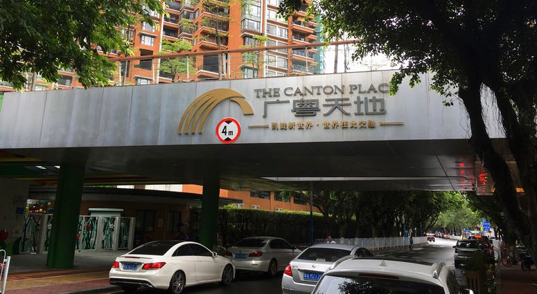 Vehicles pass by high-rise apartment buildings in The Canton Place where U.S. government workers experienced unexplained health issues in Guangzhou. Vehicles pass by high-rise apartment buildings in The Canton Place where U.S. government workers experienced unexplained health issues in Guangzhou.