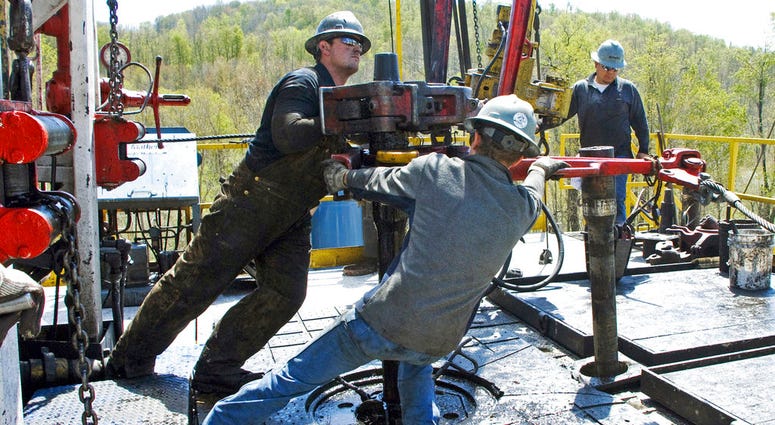 In this April 23, 2010, file photo, workers move a section of well casing into place at a Chesapeake Energy natural gas well site near the Bradford County township of Burlington, Pa. In this April 23, 2010, file photo, workers move a section of well casing into place at a Chesapeake Energy natural gas well site near the Bradford County township of Burlington, Pa.