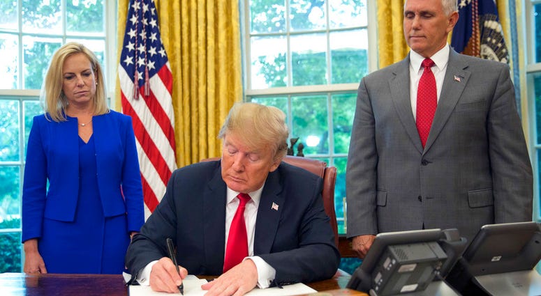 President Donald Trump signs an executive order to keep families together at the border, but says that the 'zero-tolerance' prosecution policy will continue, during an event in the Oval Office of the White House. President Donald Trump signs an executive order to keep families together at the border, but says that the 'zero-tolerance' prosecution policy will continue, during an event in the Oval Office of the White House.