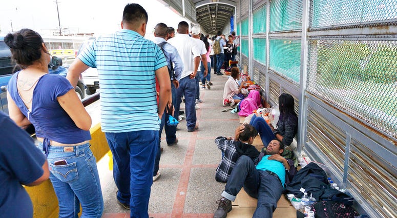Migrant families rest from their travels to Matamoros, Mexico, along Gateway International Bridge which connects to Brownsville, Texas, as they seek asylum in the United States. Migrant families rest from their travels to Matamoros, Mexico, along Gateway International Bridge which connects to Brownsville, Texas, as they seek asylum in the United States.