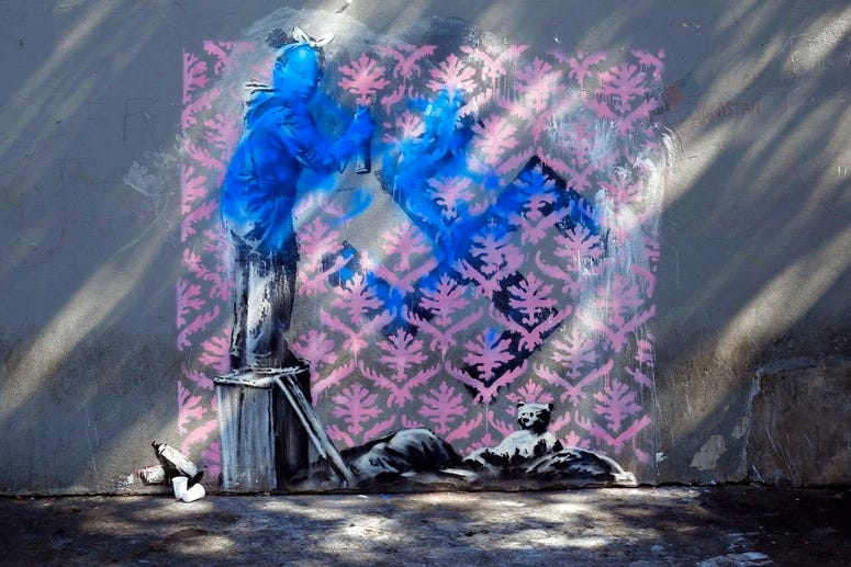 A graffiti believed to be attributed to street artist Banksy is seen on a wall in Paris. A graffiti believed to be attributed to street artist Banksy is seen on a wall in Paris.