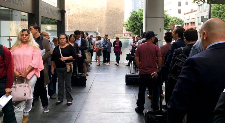 Immigrants awaiting deportation hearings line up outside the building that houses the immigration courts in Los Angeles. Immigrants awaiting deportation hearings line up outside the building that houses the immigration courts in Los Angeles.