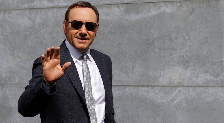 In this file photo dated Tuesday, June 21, 2016, actor Kevin Spacey waves as he arrives to attend the Giorgio Armani men's Spring-Summer 2016-2017 fashion show in Milan, Italy. Kevin Spacey