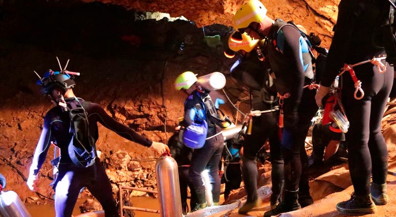 Thai rescue team members walk inside a cave where 12 boys and their soccer coach have been trapped since June 23, in Mae Sai, Chiang Rai province, northern Thailand. Thai rescue team members walk inside a cave where 12 boys and their soccer coach have been trapped since June 23, in Mae Sai, Chiang Rai province, northern Thailand.