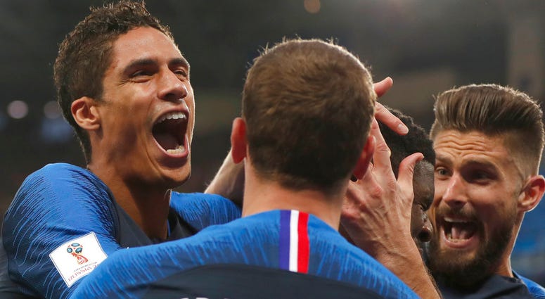 French players mob France's Samuel Umtiti after he scored the opening goal of the game during the semifinal match between France and Belgium at the 2018 soccer World Cup in the St. Petersburg Stadium. French players mob France's Samuel Umtiti after he scored the opening goal of the game during the semifinal match between France and Belgium at the 2018 soccer World Cup in the St. Petersburg Stadium.