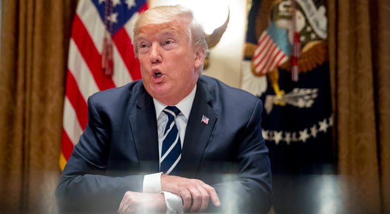 President Donald Trump speaks to members of the media as he meets with members of Congress in the Cabinet Room of the White House, Tuesday, July 17, 2018, in Washington.