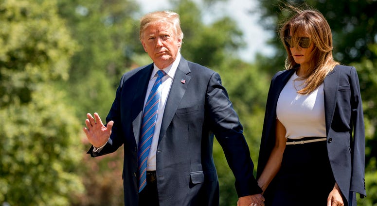 President Donald Trump, accompanied by first lady Melania Trump, waves to members of the media as they arrive on the South Lawn of the White House in Washington, Wednesday, July 18, 2018. President Donald Trump, accompanied by first lady Melania Trump, waves to members of the media as they arrive on the South Lawn of the White House in Washington, Wednesday, July 18, 2018.