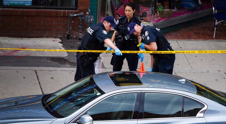 Police investigate a car at the scene of a shooting in Toronto, on Monday, July 23, 2018. Police investigate a car at the scene of a shooting in Toronto, on Monday, July 23, 2018.