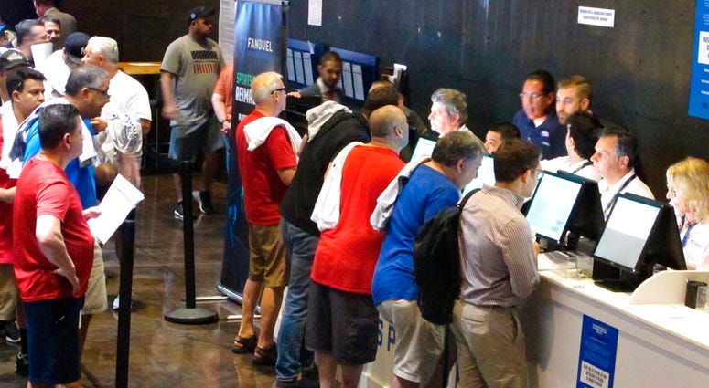This July 14, 2018, photo shows people placing bets on sporting events at the Meadowlands Racetrack in East Rutherford N.J. This July 14, 2018, photo shows people placing bets on sporting events at the Meadowlands Racetrack in East Rutherford N.J.
