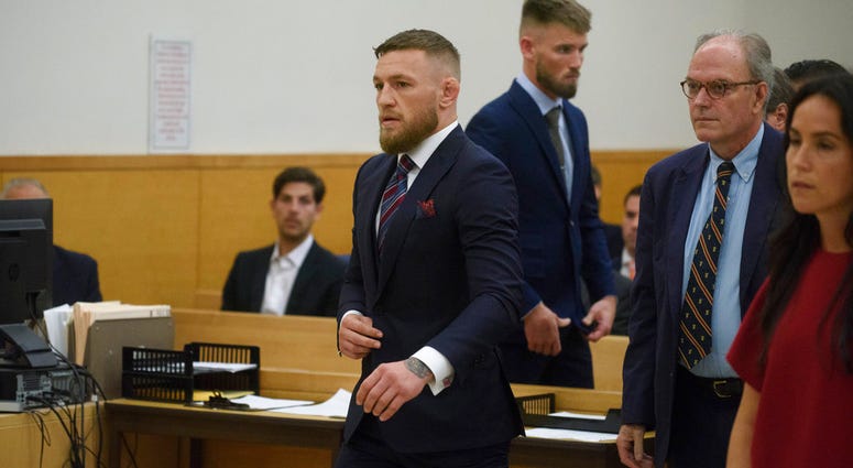 Mixed martial arts fighters Conor McGregor, center, and co-defendant Cian Cowley, third from left, appear in court, Thursday, July 26, 2018, in New York. Conor McGregor