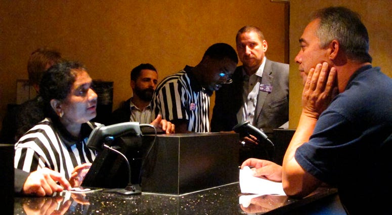 A clerk at the new sports book at Harrah's casino in Atlantic City N.J. process wagers for a customer moments after the casino started accepting sports bets on Wednesday Aug. 1, 2018. A clerk at the new sports book at Harrah's casino in Atlantic City N.J. process wagers for a customer moments after the casino started accepting sports bets on Wednesday Aug. 1, 2018.
