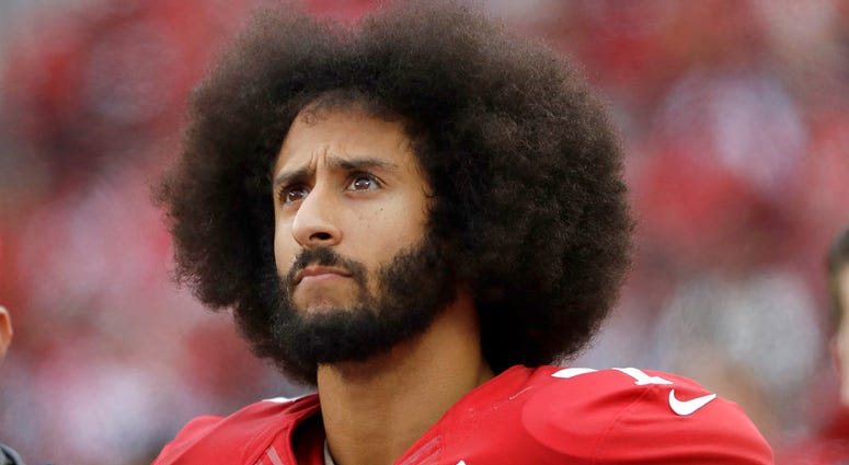 In this Dec. 11, 2016, file photo, San Francisco 49ers quarterback Colin Kaepernick stands in the bench area during the second half of the team's NFL football game against the New York Jets in Santa Clara, Calif. Colin Kaepernick