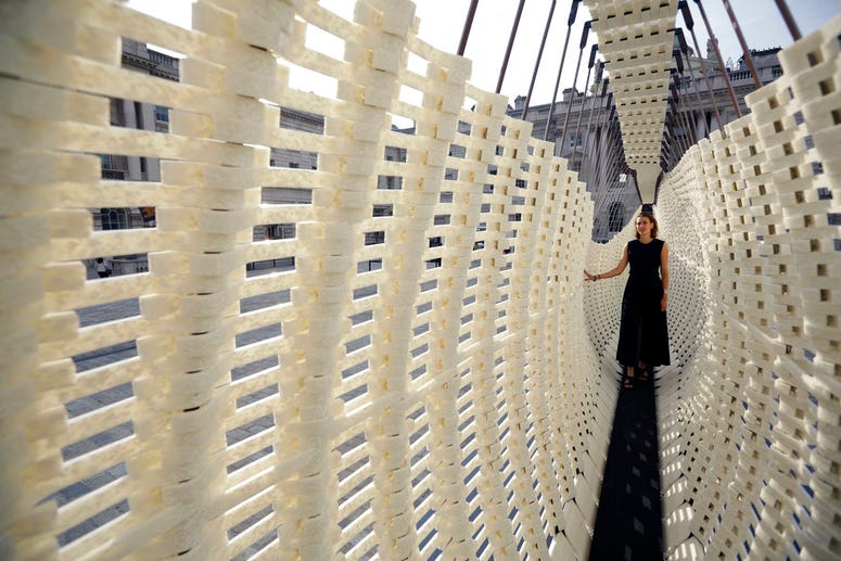 The Greek exhibit "Disobedience", with designer Nassia Inglessis posing, a 17 metre-long wall constructed from a steel spring skeleton built up with recycled plastic which flexes, is displayed during a preview for the London Design Biennale. The Greek exhibit "Disobedience", with designer Nassia Inglessis posing, a 17 metre-long wall constructed from a steel spring skeleton built up with recycled plastic which flexes, is displayed during a preview for the London Design Biennale.