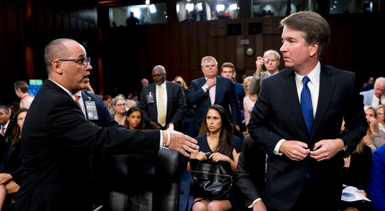 Fred Guttenberg, the father of Jamie Guttenberg who was killed in the Stoneman Douglas High School shooting in Parkland, Fla., left, attempts to shake hands with Brett Kavanaugh, right, as he leaves for a lunch break. Fred Guttenberg, the father of Jamie Guttenberg who was killed in the Stoneman Douglas High School shooting in Parkland, Fla., left, attempts to shake hands with Brett Kavanaugh, right, as he leaves for a lunch break.