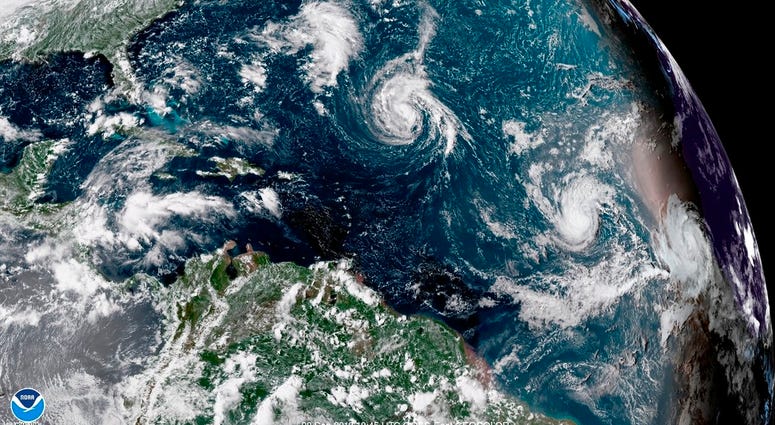 This enhanced satellite image made available by NOAA shows Tropical Storm Florence, center, in the Atlantic Ocean on Saturday, Sept. 8, 2018 at 2:45 p.m. EDT. This enhanced satellite image made available by NOAA shows Tropical Storm Florence, center, in the Atlantic Ocean on Saturday, Sept. 8, 2018 at 2:45 p.m. EDT.