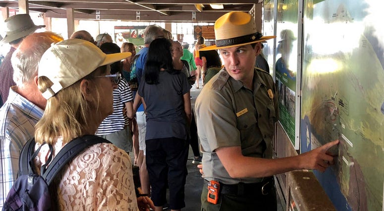 In this Saturday, Sept. 22,2018, photo released by the National Park Service shows tourists get directions on the first day Hawaii Volcanoes National Park is reopened after volcanic activity forced the park to close for more than four months in Hawaii. In this Saturday, Sept. 22,2018, photo released by the National Park Service shows tourists get directions on the first day Hawaii Volcanoes National Park is reopened after volcanic activity forced the park to close for more than four months in Hawaii.