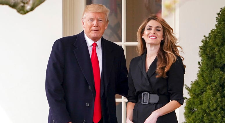In this March 29, 2018, file photo, President Donald Trump poses for members of the media with then White House Communications Director Hope Hicks on her last day before he boards Marine One on the South Lawn of the White House in Washington. President Donald Trump poses for members of the media with then White House Communications Director Hope Hicks.