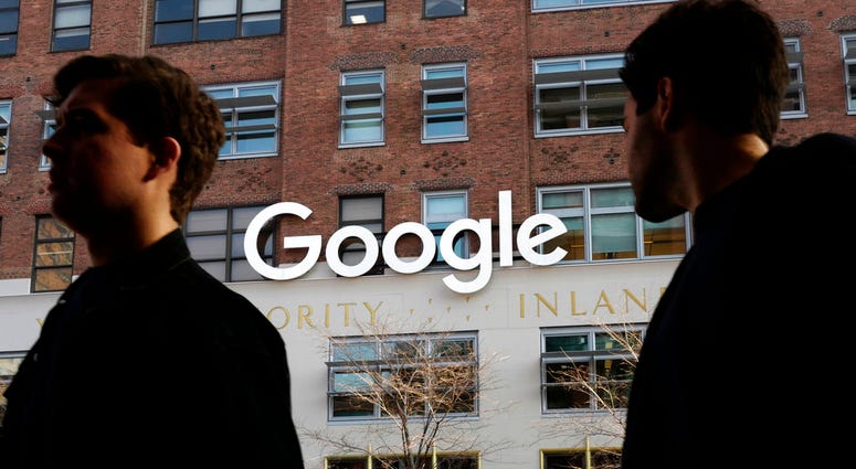 In this Dec. 4, 2017 file photo, people walk by Google offices in New York. In this Dec. 4, 2017 file photo, people walk by Google offices in New York.