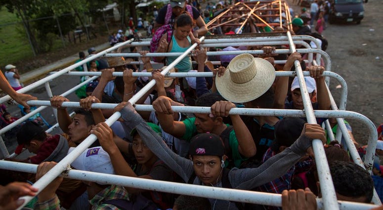 Migrants travel on a cattle truck, as a thousands-strong caravan of Central American migrants slowly makes its way toward the U.S. border, between Pijijiapan and Arriaga, Mexico, Friday, Oct. 26, 2018. Migrants travel on a cattle truck, as a thousands-strong caravan of Central American migrants slowly makes its way toward the U.S. border, between Pijijiapan and Arriaga, Mexico, Friday, Oct. 26, 2018.