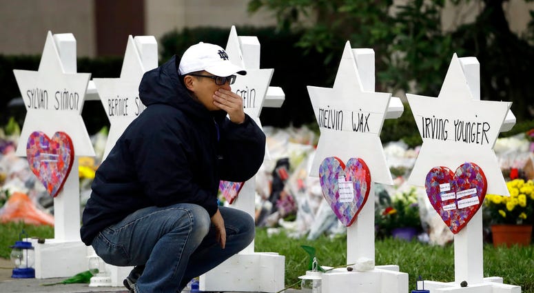 A person pauses in front of Stars of David with the names of those killed in a deadly shooting at the Tree of Life Synagogue, in Pittsburgh, Monday, Oct. 29, 2018. A person pauses in front of Stars of David with the names of those killed in a deadly shooting at the Tree of Life Synagogue, in Pittsburgh, Monday, Oct. 29, 2018.