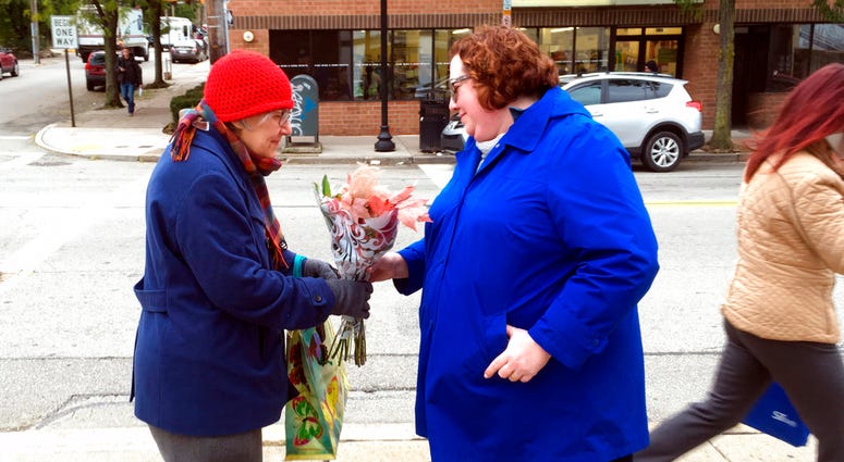 Kristin Wessell, right, hands a bouquet of flowers to Marianne Novy on Murray Avenue in the Squirrel Hill neighborhood of Pittsburgh, Monday, Oct. 29, 2018. Kristin Wessell, right, hands a bouquet of flowers to Marianne Novy on Murray Avenue in the Squirrel Hill neighborhood of Pittsburgh, Monday, Oct. 29, 2018.