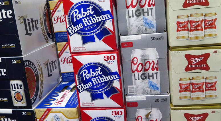 FILE - In this Nov. 8, 2018, file photo, cases of Pabst Blue Ribbon and Coors Light are stacked next to each other in a Milwaukee liquor store. FILE - In this Nov. 8, 2018, file photo, cases of Pabst Blue Ribbon and Coors Light are stacked next to each other in a Milwaukee liquor store.