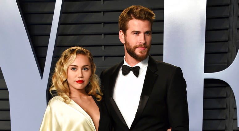 Miley Cyrus, left, and Liam Hemsworth arrive at the Vanity Fair Oscar Party in Beverly Hills, California, on March 4, 2018. Miley Cyrus and Liam Hemsworth