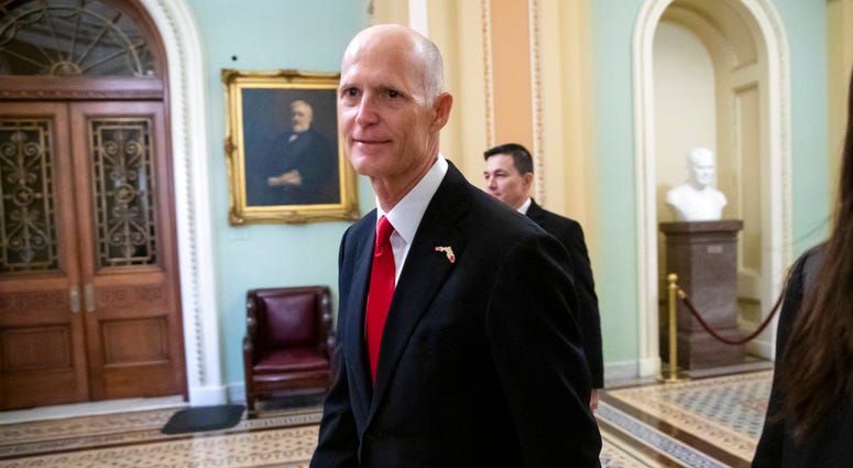 FILE- In this Wednesday, Nov. 14, 2018, file photo Florida Gov. Rick Scott arrives for a meeting with Majority Leader Mitch McConnell, R-Ky., and new GOP senators at the Capitol in Washington. FILE- In this Wednesday, Nov. 14, 2018, file photo Florida Gov. Rick Scott arrives for a meeting with Majority Leader Mitch McConnell, R-Ky., and new GOP senators at the Capitol in Washington.