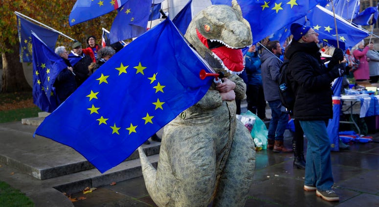 An Anti Brexit campaigner dressed a dinosaur demonstrates in Westminster in London, Monday, Nov. 19, 2018. An Anti Brexit campaigner dressed a dinosaur demonstrates in Westminster in London, Monday, Nov. 19, 2018.