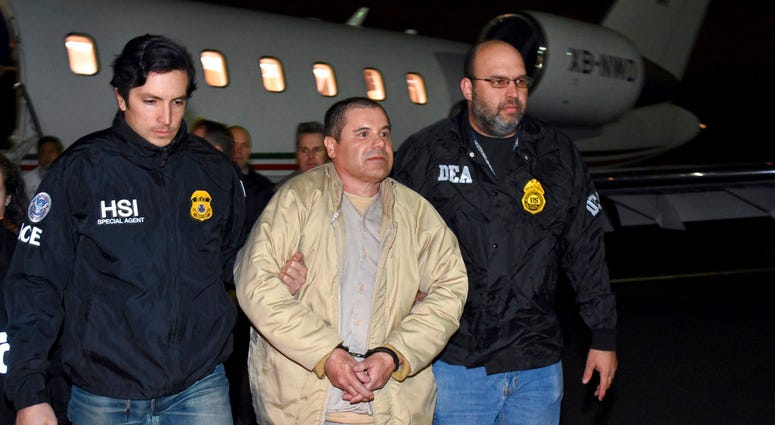 FILE - In this Jan. 19, 2017, file photo, provided by U.S. law enforcement, authorities escort Joaquin "El Chapo" Guzman, center, from a plane to a waiting caravan of SUVs at Long Island MacArthur Airport, in Ronkonkoma, N.Y. FILE - In this Jan. 19, 2017, file photo, provided by U.S. law enforcement, authorities escort Joaquin "El Chapo" Guzman, center, from a plane to a waiting caravan of SUVs at Long Island MacArthur Airport, in Ronkonkoma, N.Y.