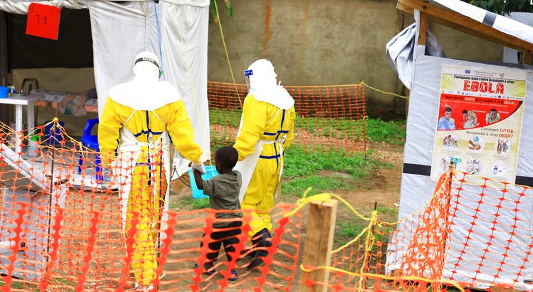 FILE - In this file photo dated Sunday, Sept. 9, 2018, health workers walk with a boy suspected as having the Ebola virus at an Ebola treatment centre in Beni, Eastern Congo. FILE - In this file photo dated Sunday, Sept. 9, 2018, health workers walk with a boy suspected as having the Ebola virus at an Ebola treatment centre in Beni, Eastern Congo.