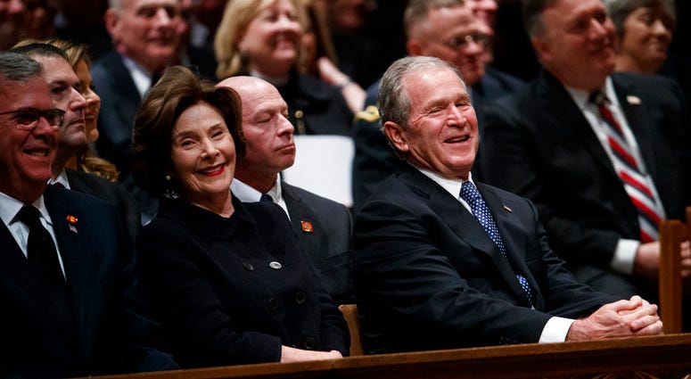 Jeb Bush, Laura Bush, and former President George W. Bush share a laugh as a story is told about former President George H.W. Bush during a State Funeral at the National Cathedral, Wednesday, Dec. 5, 2018, in Washington. Jeb Bush, Laura Bush, and former President George W. Bush share a laugh as a story is told about former President George H.W. Bush during a State Funeral at the National Cathedral, Wednesday, Dec. 5, 2018, in Washington.