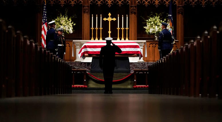 People pay their respects as the flag-draped casket of former President George H.W. Bush lies in repose at St. Martin's Episcopal Church Wednesday, Dec. 5, 2018, in Houston. People pay their respects as the flag-draped casket of former President George H.W. Bush lies in repose at St. Martin's Episcopal Church Wednesday, Dec. 5, 2018, in Houston.